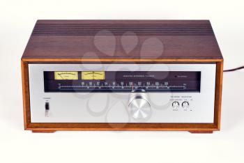 Vintage Stereo Audio Tuner Radio in Wooden cabinet on white background, frontal view