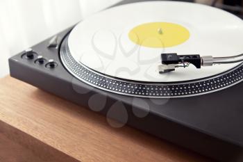 Vintage Record Turntable Plays White Vinyl Disk Angled View