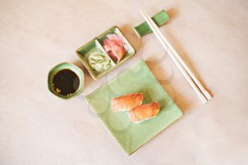 japanese sushi on the green plate and chopsticks