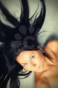seducting brunette lying on the gray background (crossprocessed)