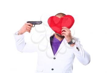 strong latino man 20-25 years  with heart and pistol  in studio on  white background