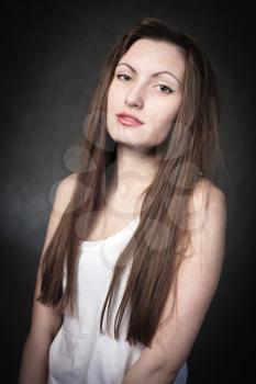 Portrait of a young brunette lady on white background