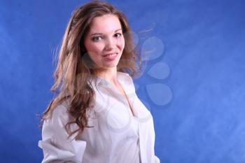 Portrait of a charming young lady on blue background