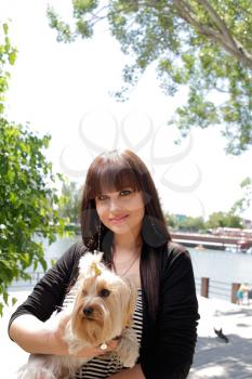 Fashion portrait of beautiful woman with small dog