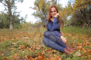 happy young woman outdoors in the field in autumn