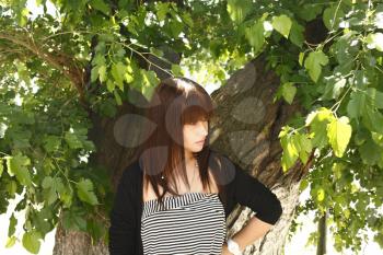 Beautiful brunette girl outdoors in summer