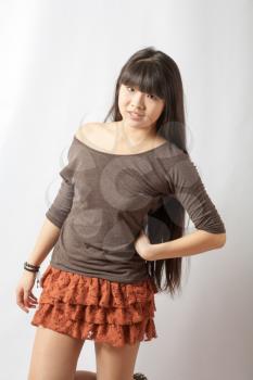 Beautiful young asian model. Studio shot. Cheerful young Asian girl, half length closeup portrait on white background.