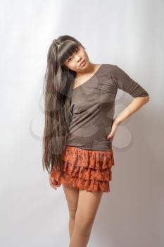 Beautiful young asian model. Studio shot. Cheerful young Asian girl, half length closeup portrait on white background.