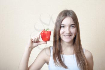 beautiful girl with red sweet pepper - organic food and health concept