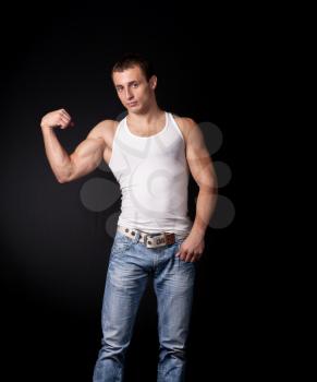 Handsome muscle men athlete on a black background