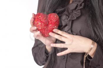 red heart in womens hands closeup over white background.