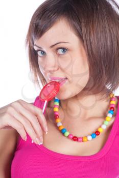 Young woman with candy on white
