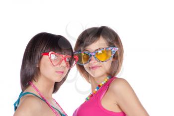 Two beautiful girl in funny glasses isolated on white