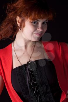 Portrait of beautiful redhead girl on black background