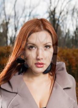 foxy-red haired women outdoors weared jacket at autumn time