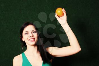 Woman with fruit. Female with an orange in her hands