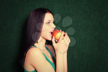Royalty Free Photo of a Woman Biting an Apple