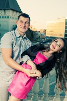 Smiling young couple outdoors having fun