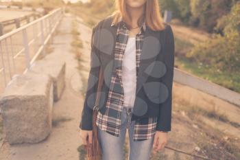 Alone outdoors. Female weared jeans colorized image
