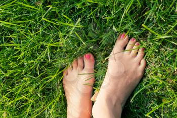 Foot over green grass.
