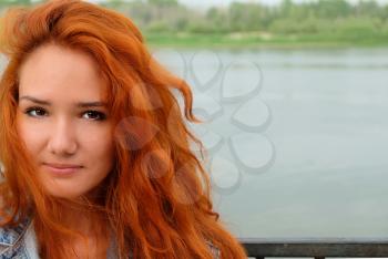 Closeup image of a young redhead women and a lot of copyspace.