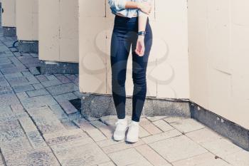 Hipster girl legs against wall a lot of copy space