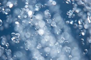 Water drops levitating in the air, blurred and in-focus