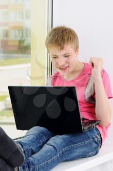 Royalty Free Photo of a Teenager Watching a Laptop