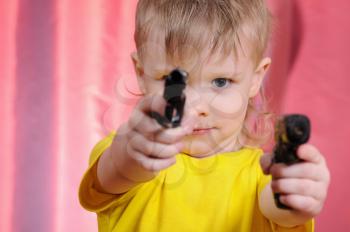 Royalty Free Photo of a Child Holding Toy Guns