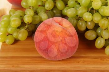 Royalty Free Photo of a Peach and Grapes