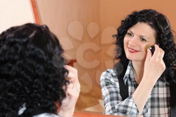 Royalty Free Photo of a Woman Applying Makeup