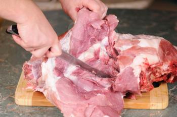 Royalty Free Photo of a Person Cutting Meat