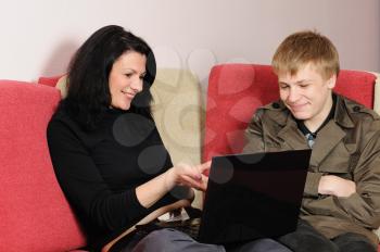 Royalty Free Photo of a Mother and Son Looking at a Laptop