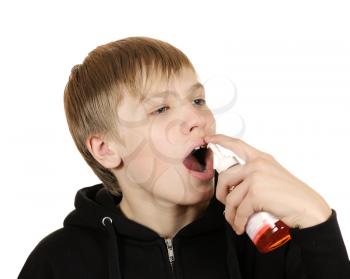 Royalty Free Photo of a Teenager Using an Inhaler