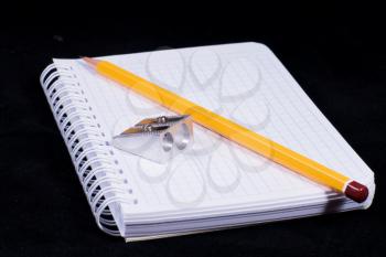 Royalty Free Photo of a Pencil on a Notebook