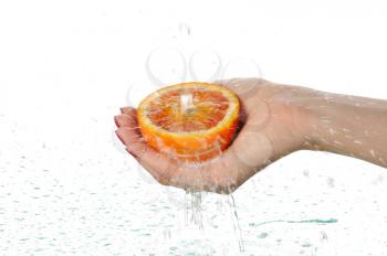 Royalty Free Photo of a Person Washing a Red Orange
