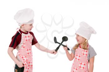 Two children dressed in chef isolated on the white background