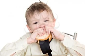 thoughtful boy eating a sandwich with his tie
