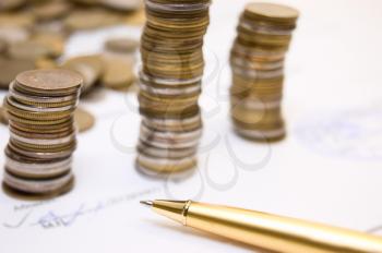 Royalty Free Photo of Coins on a Contract