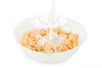 Milk pouring in a bowl of cornflakes closeup