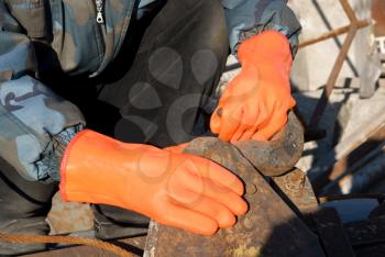 Royalty Free Photo of a Close-up of a Worker's Orange Gloves