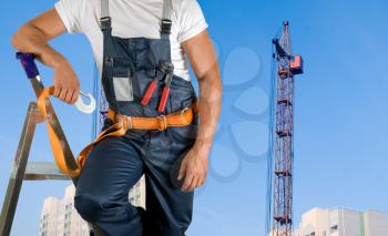 Royalty Free Photo of a Steeplejack Closeup on a Building Background