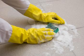 Royalty Free Photo of a Person Scrubbing the Floor