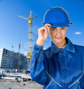 Royalty Free Photo of a Female Builder on a Building Background