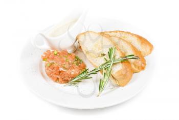 Tar-tar from salmon fish with green onion. Served with honey sauce and white bread toast.