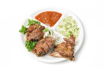 Grilled meat with sauce and vegetables isolated on white background