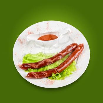 Royalty Free Photo of Grilled Sausage on Lettuce