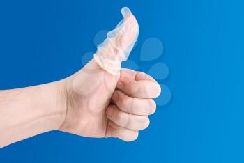 Royalty Free Photo of a Hand With a Condom On It