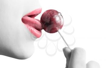 Royalty Free Photo of a Woman Sucking on a Lollipop