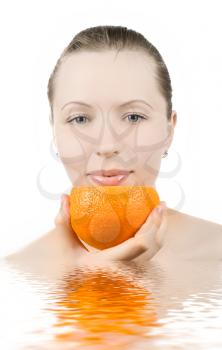 Royalty Free Photo of a Woman Holding an Orange in Water